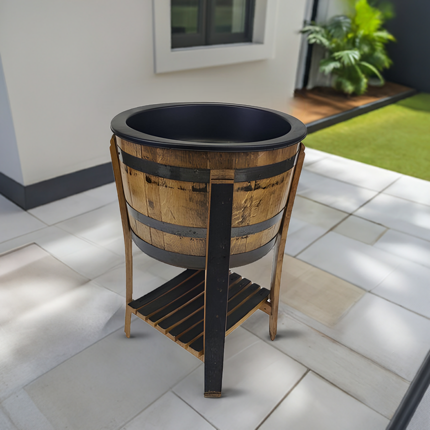 A ½ Barrel Cooler No Top is set on a tiled patio near a modern house and greenery, highlighting its sturdy design and stylish presence.