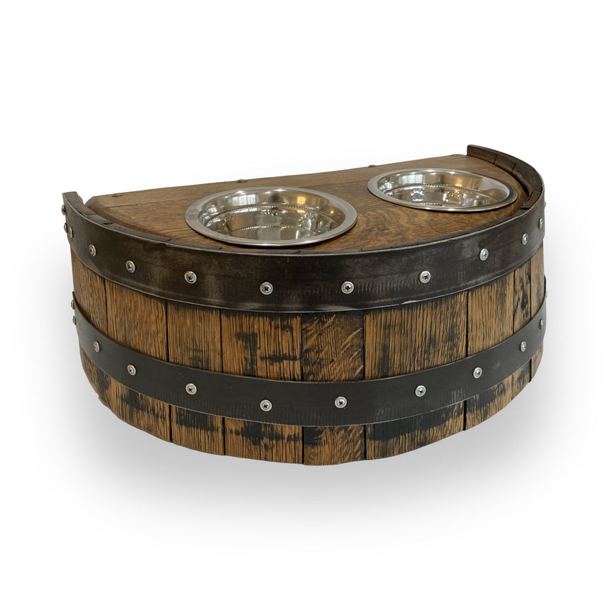 The Whiskey Barrel Pet Feeder showcases a wood barrel-inspired design with two stainless steel bowls in a semi-circular wooden base, bringing elegance and practicality to your pet’s mealtime.