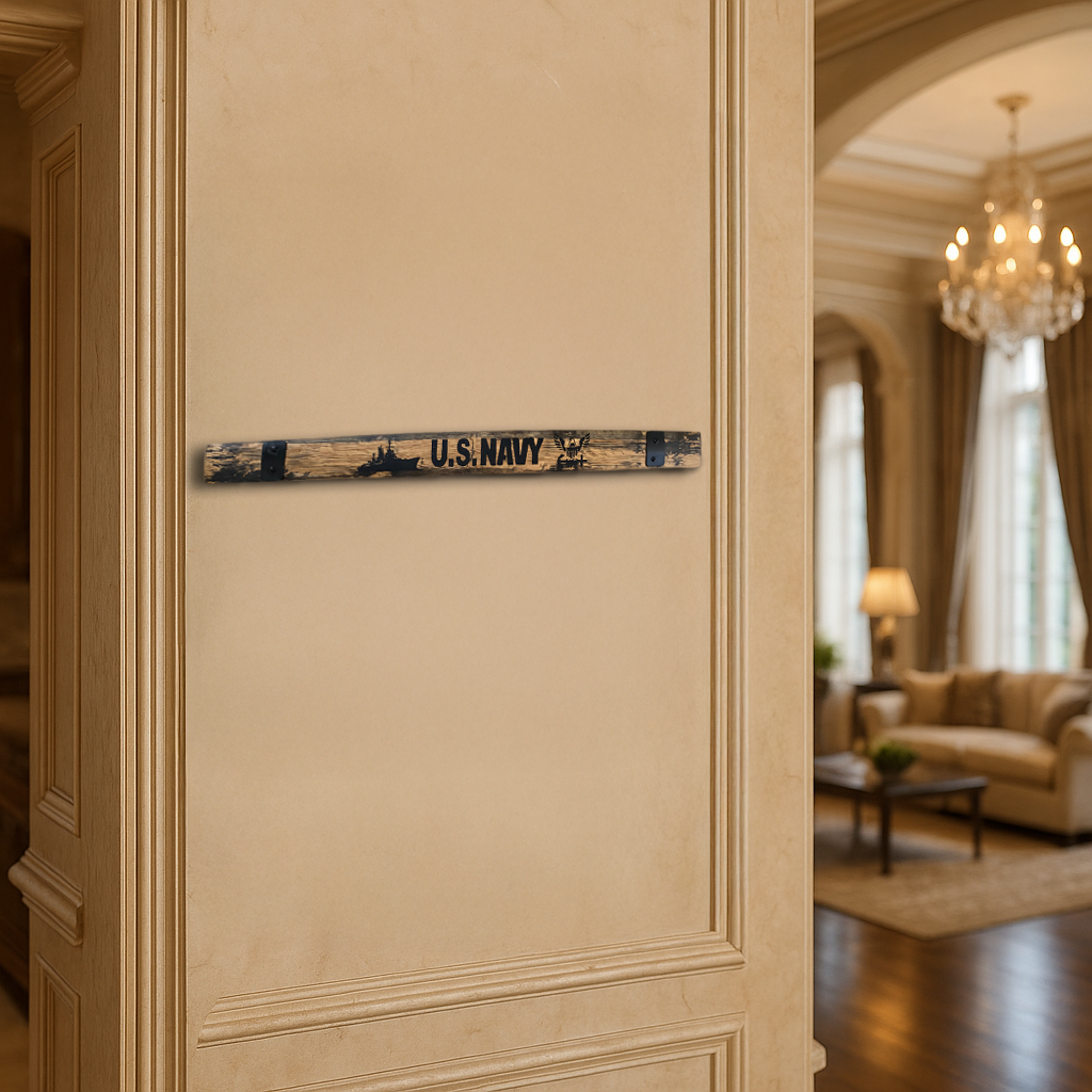 A "U.S. NAVY" sign made from Barrel Staves reclaimed oak hangs on a beige wall in an elegant, well-lit room.