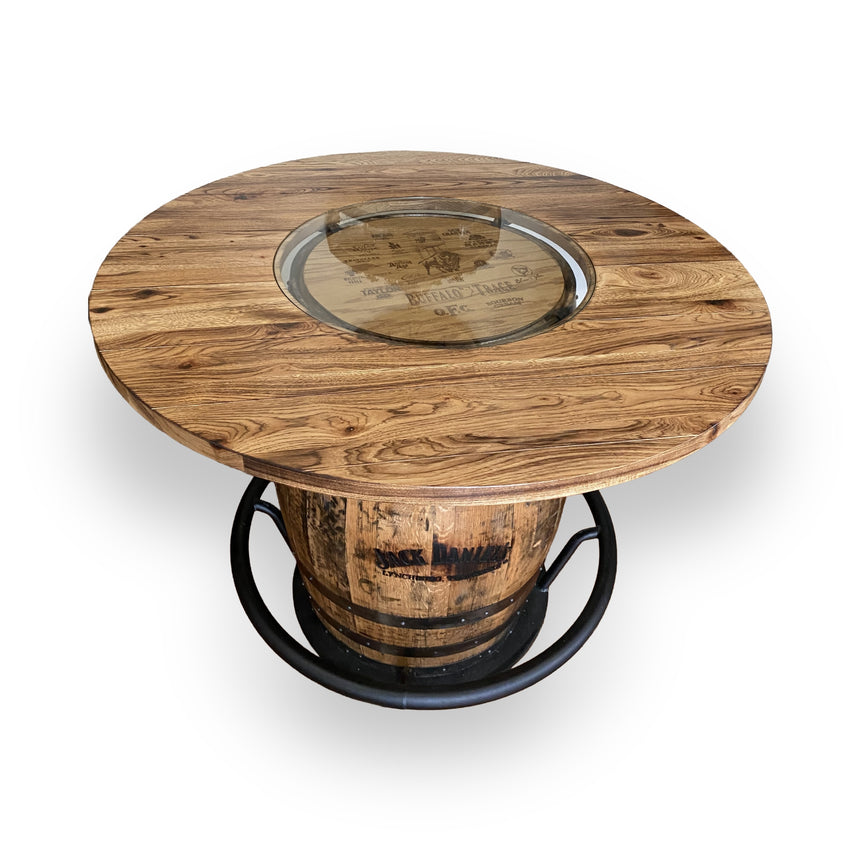 The Whiskey Barrel Pub Table features a 48-inch burnt hickory tabletop with a glass inset and handmade solid wood barrel construction, offering rustic charm and durability.
