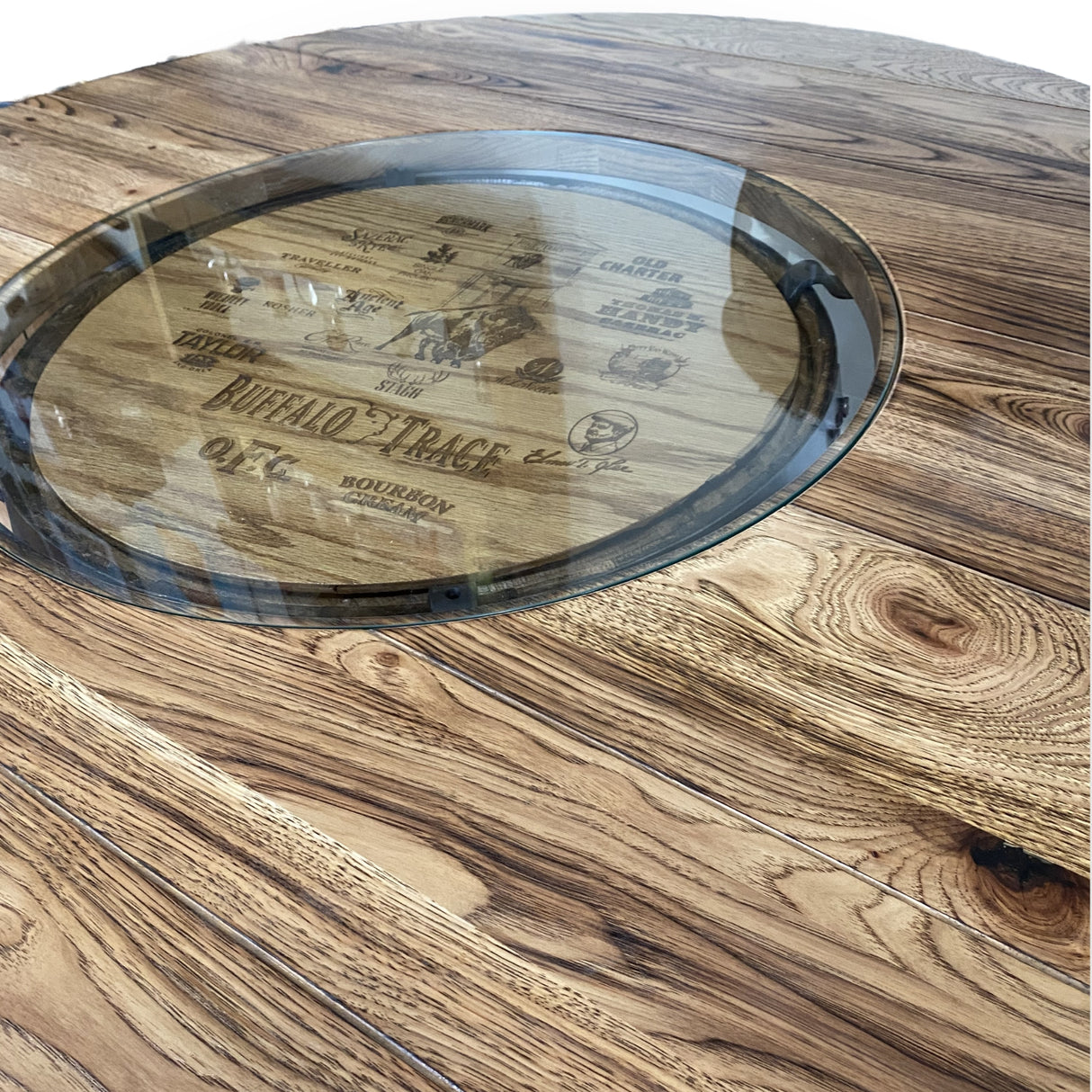 A close-up of the Whiskey Barrel Pub Table, featuring a 48-inch burnt hickory tabletop with glass inset and handmade solid wood barrel construction.