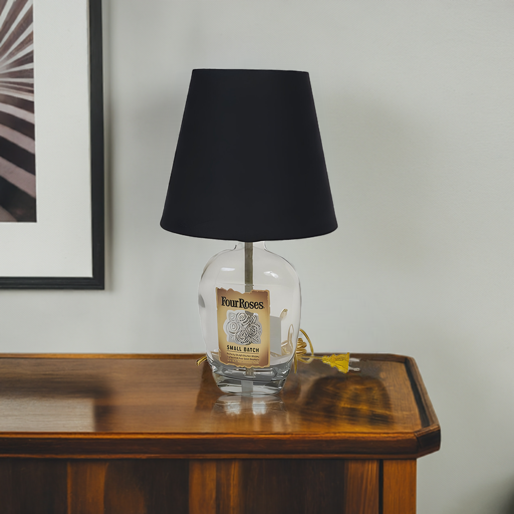 The Four Roses Lamp pairs a black shade with a base made from a Four Roses bourbon bottle, adding rustic elegance and warm ambient light to any space.