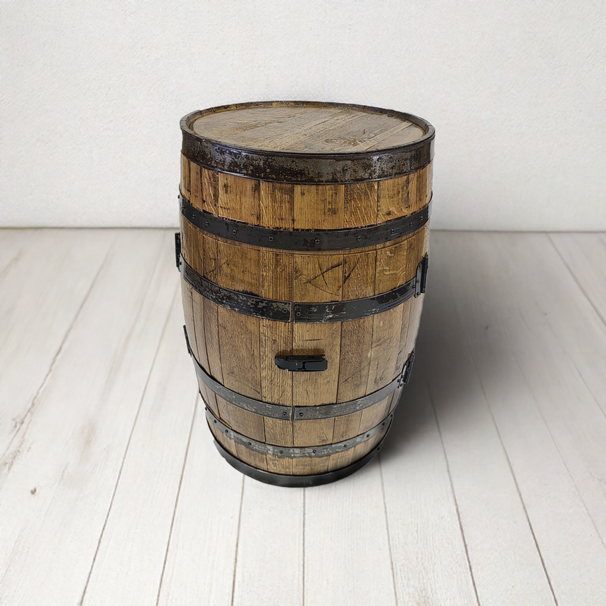 A Full Barrel Cabinet with shelves and glassware holders, featuring full bar and hand-made wood barrel construction, sits against a plain wall on a light wooden floor, bringing rustic charm to the space.