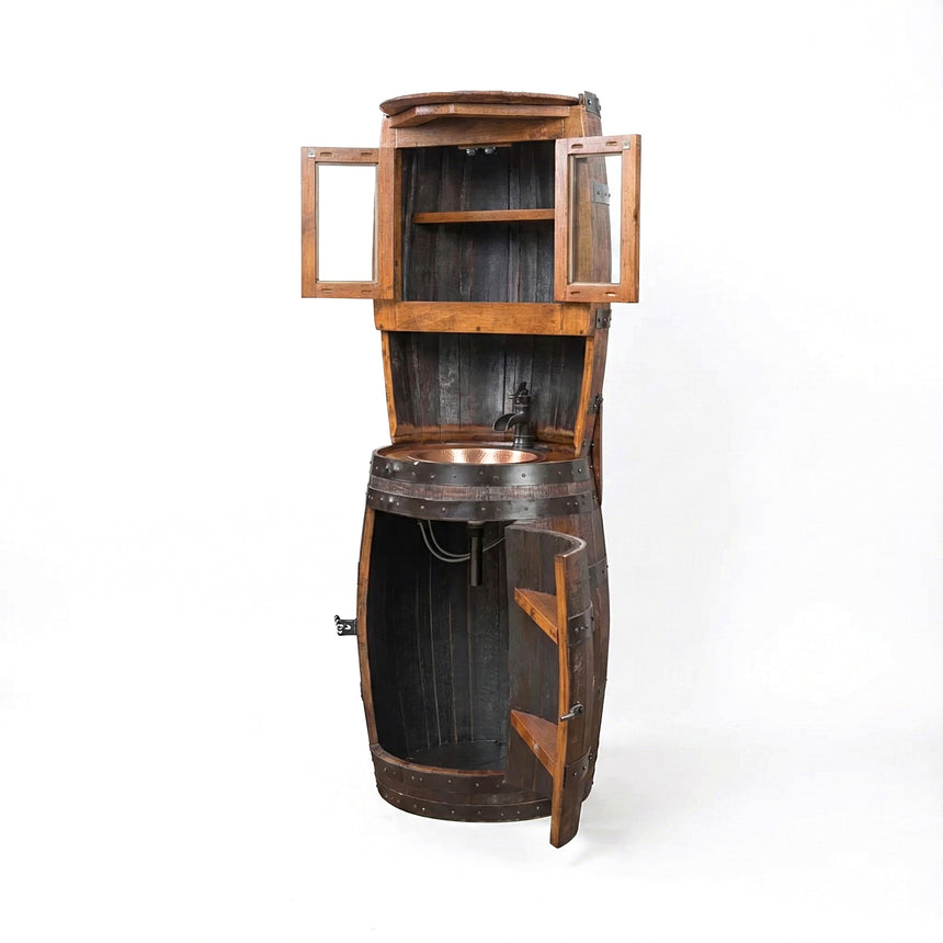 The Barrel Vanity is a rustic wooden whiskey barrel repurposed as a standing sink, featuring open cabinet doors and shelves.