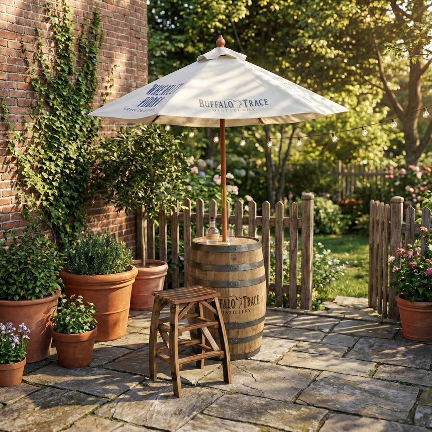 A patio with potted plants, a Patio Pub Table made from a reclaimed whiskey barrel, a stool, and a large white Buffalo Trace umbrella.