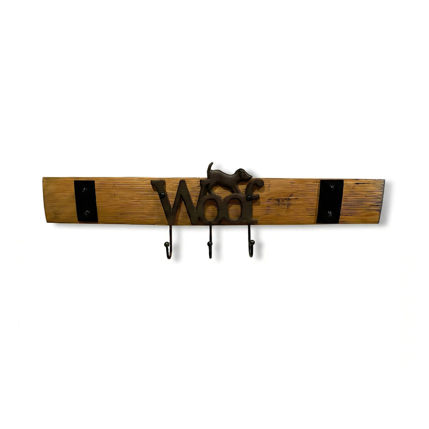 The Leash Holder, made from whiskey barrel staves, features the word "Woof," a dog figure, and three metal hooks for a charming and functional pet leash organizer.