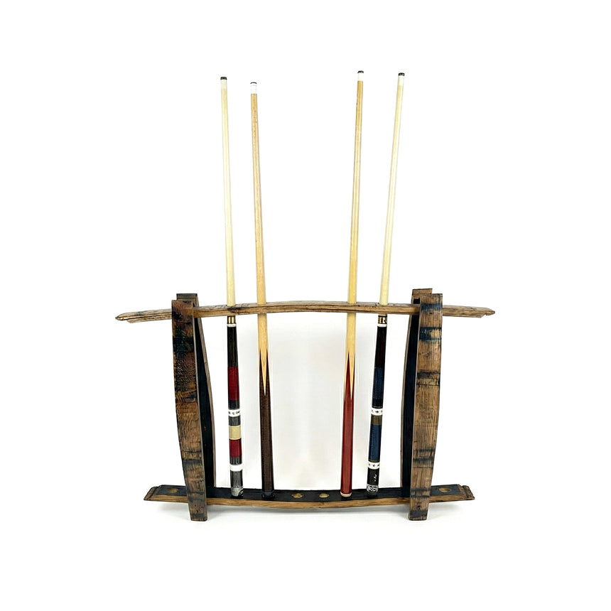 Four pool cues stand upright in a freestanding, hand made solid wood barrel stave cue rack that holds up to 8 billiard sticks, set against a white background.