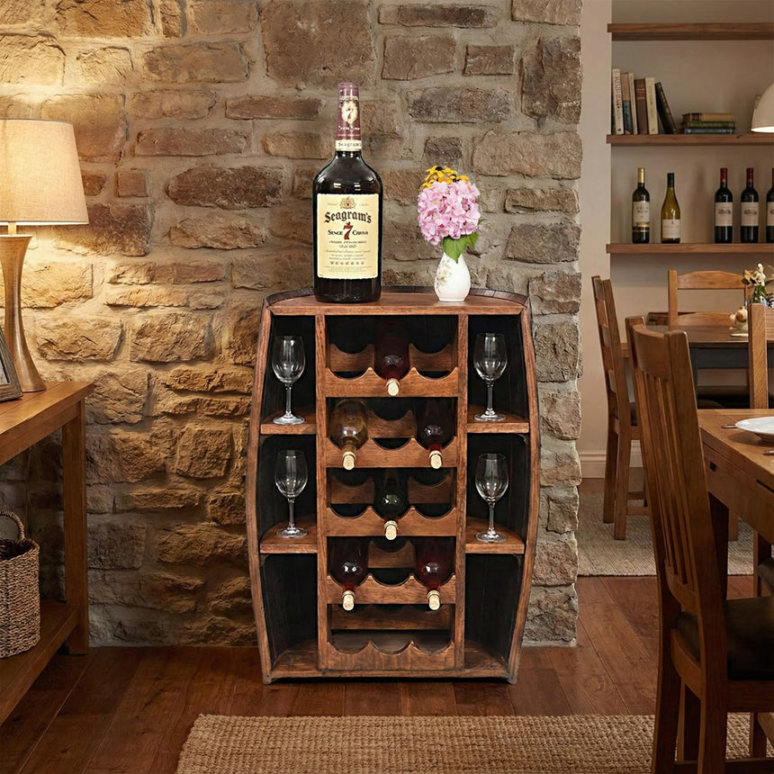 Wood wine rack with bottles, glasses, a liquor bottle, and a vase of flowers against a stone wall—ideal rustic home bar decor or pair it with the Half Barrel Bottle Holder for extra charm.