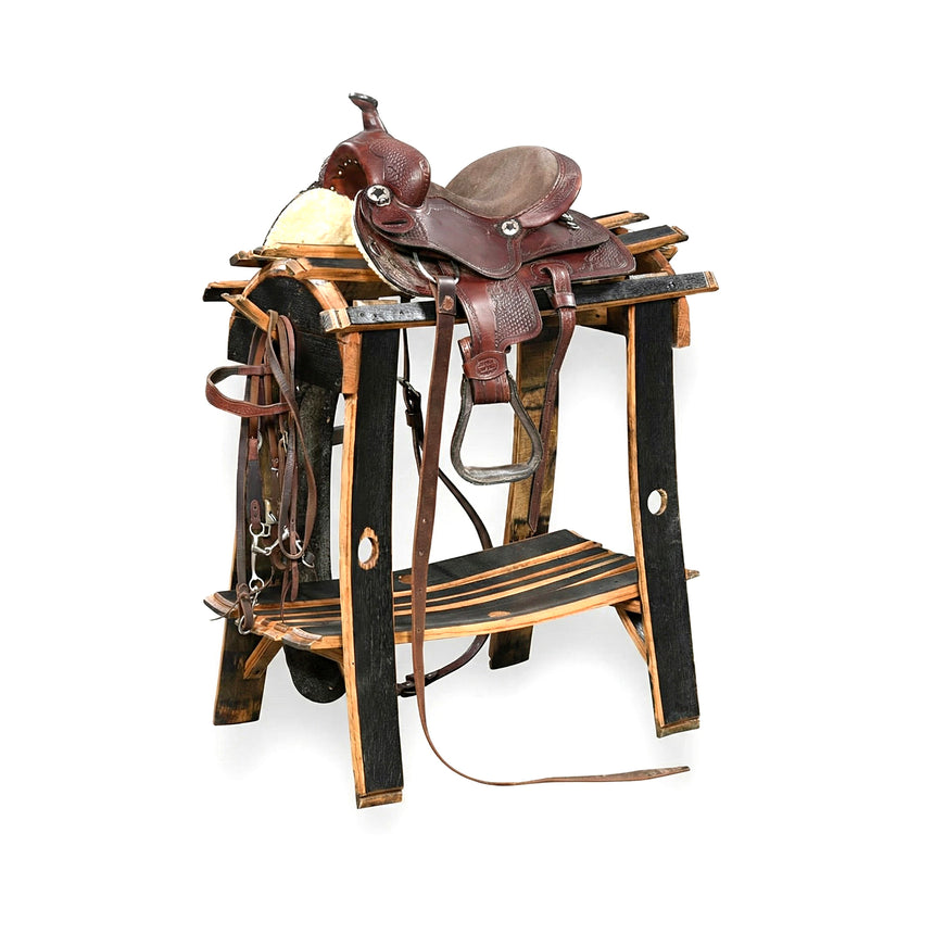 A brown leather horse saddle sits on the Saddle Stand, with reins neatly draped on the side.