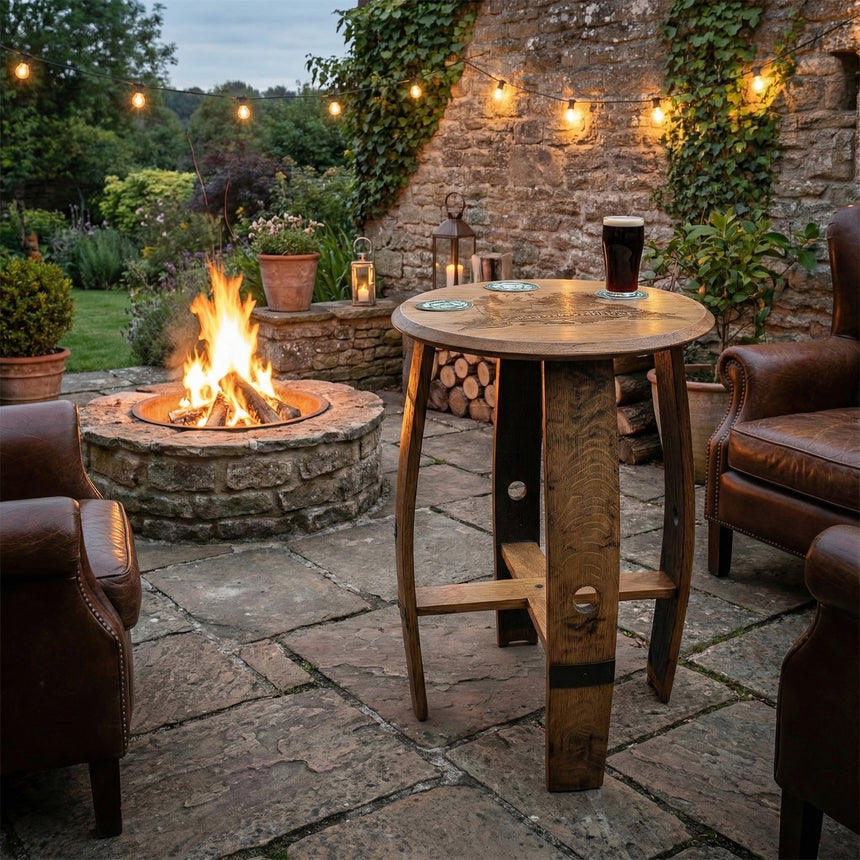 Cozy patio with fire pit, Pub Table, leather chairs, string lights, and lush greenery.