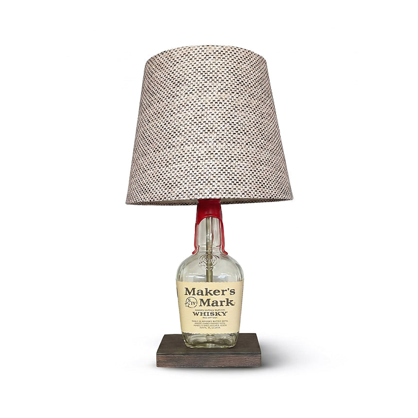 Brighten your space with the Maker's Mark Lamp, crafted from a bourbon bottle and topped with a patterned fabric shade—an ideal piece to add distinctive charm to your home decor.