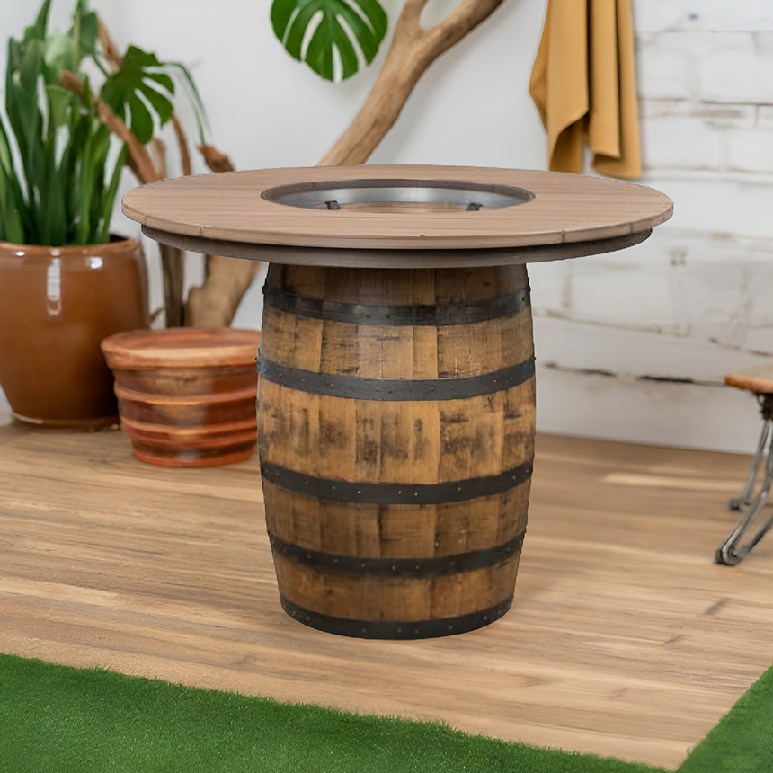 The Outdoor Barrel Table With Poly Top features a round design made from genuine bourbon barrels, water-resistant, and is displayed on a wooden floor with surrounding plants.