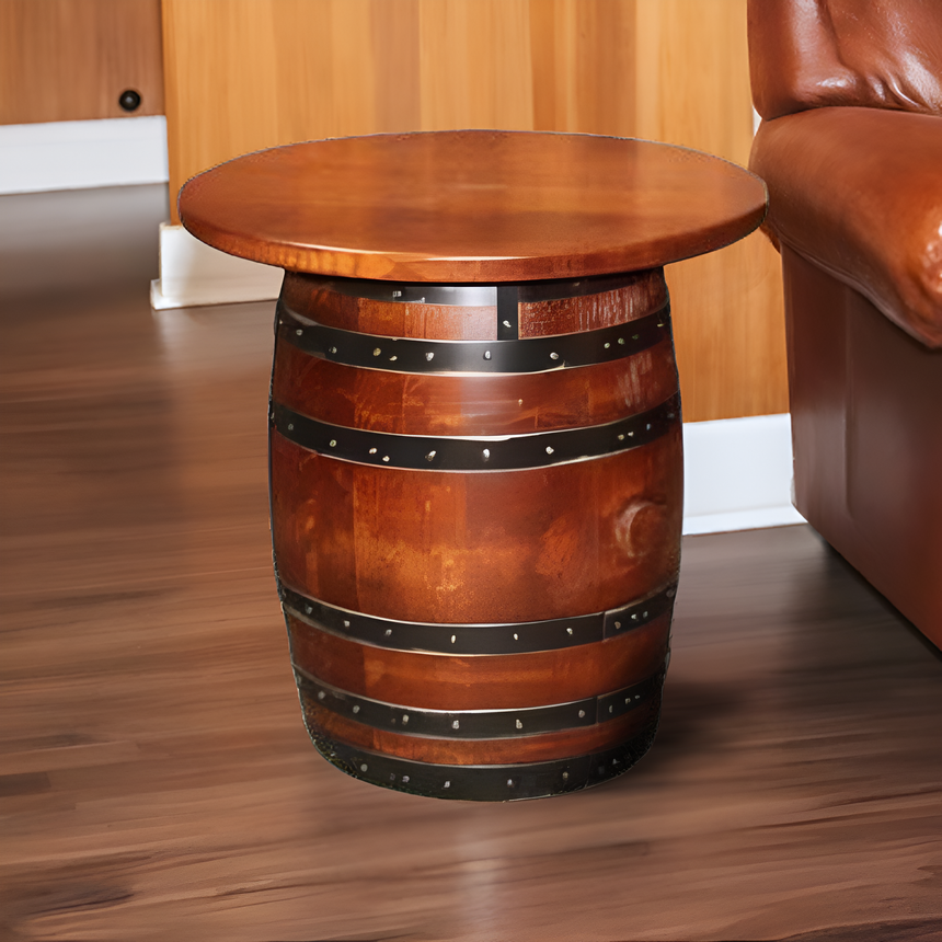 The Small Barrel End Table sits next to a brown leather sofa on wood flooring.