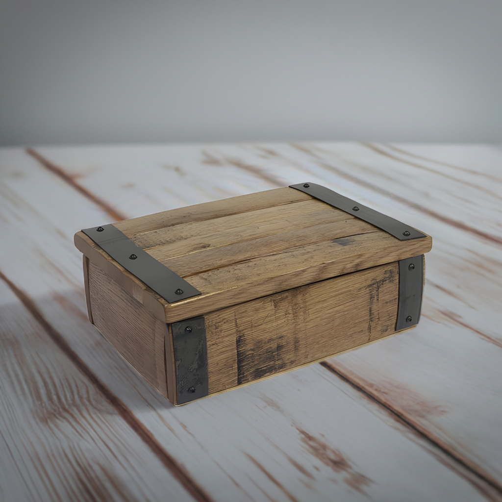 The Small Stave Box, built with sturdy construction and reinforced metal corners, rests on a white wooden surface.