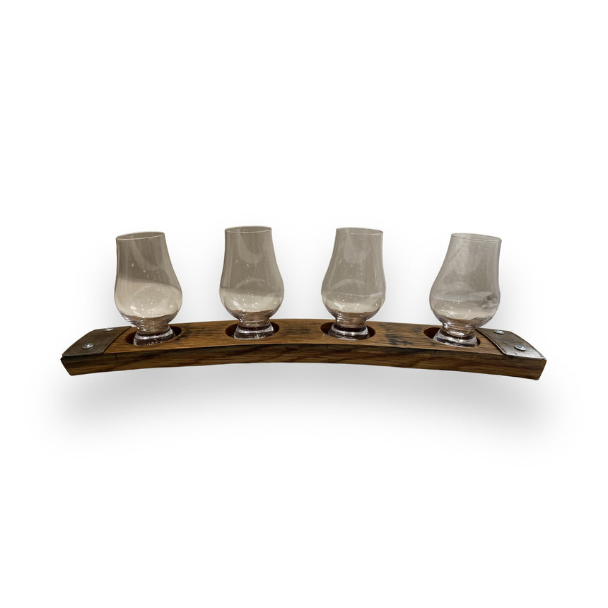 Four empty whiskey glasses rest on a Whiskey Tasting Flight Board for 4 Glasses, hand made with solid wood construction and metal accents, displayed against a white background.