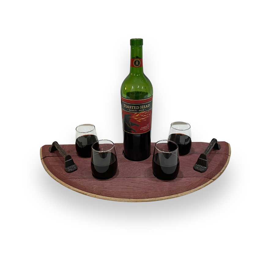 A bottle of red wine and four filled glasses are arranged on the Wine Tasting Tray - Wine Barrel Head, featuring a unique design and sturdy handles for easy serving.
