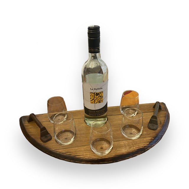 The Wine Tasting Tray, crafted from handcrafted barrel heads, holds a bottle of white wine and four glasses, adding rustic elegance to any gathering.