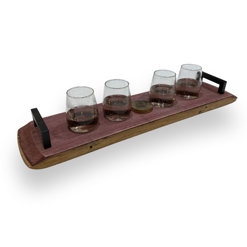 Four glasses with brown liquid sit on the Wine Barrel Serving Board, made from reclaimed barrels and featuring metal handles, all on a white background.