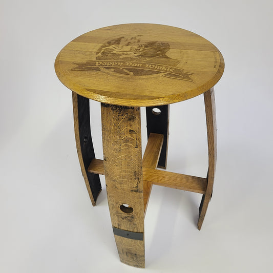 Elegant and versatile, this round wooden stool features "Pappy Van Winkle" engraved on the seat and metal supports on the legs. Perfect for enhancing your Pub Table - T005 setup, it adds charm to any dining and social experience with a price range of $200.00 to $400.00.