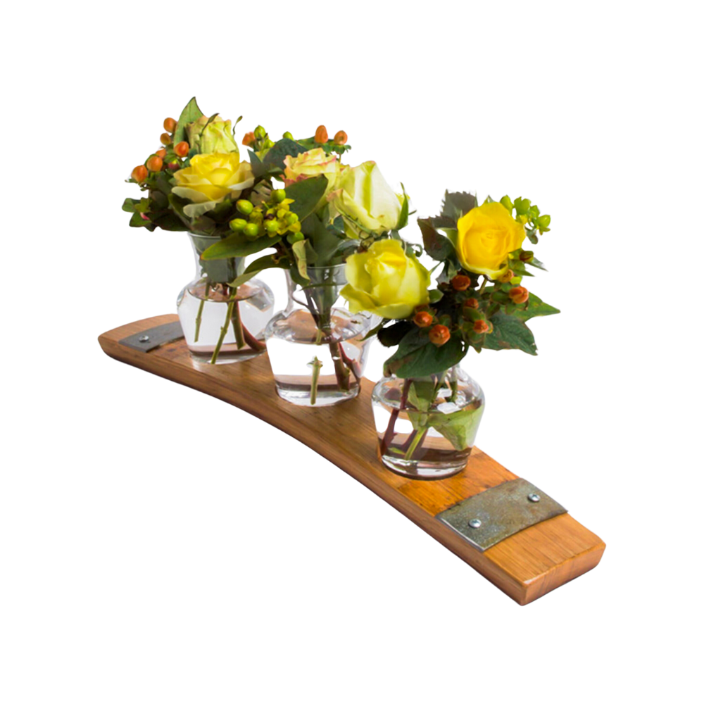 Three small glass vases with yellow roses and greenery rest elegantly on the Bud Vase Stand, a curved wooden creation crafted from reclaimed whiskey barrels.