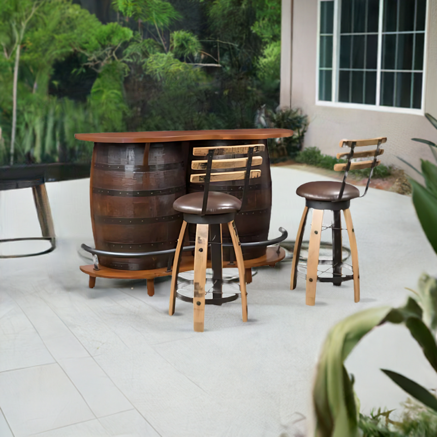 The Barrel Bar Table with Chairs adds rustic elegance to a patio, complemented by lush greenery in the background.