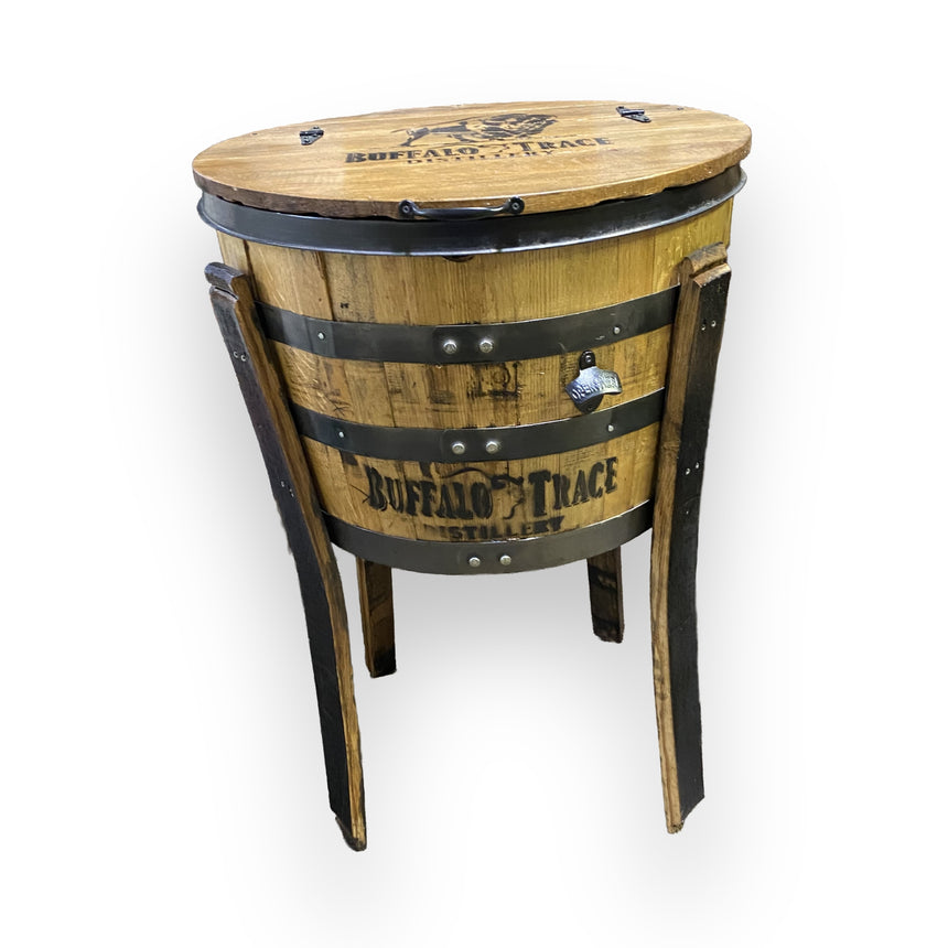 The Outdoor Bottle Cooler fits whiskey, wine, and beer bottles, featuring hand-made solid wood barrel construction with a hinged lid, metal bands, and three wooden legs—ideal for keeping drinks cool outdoors.