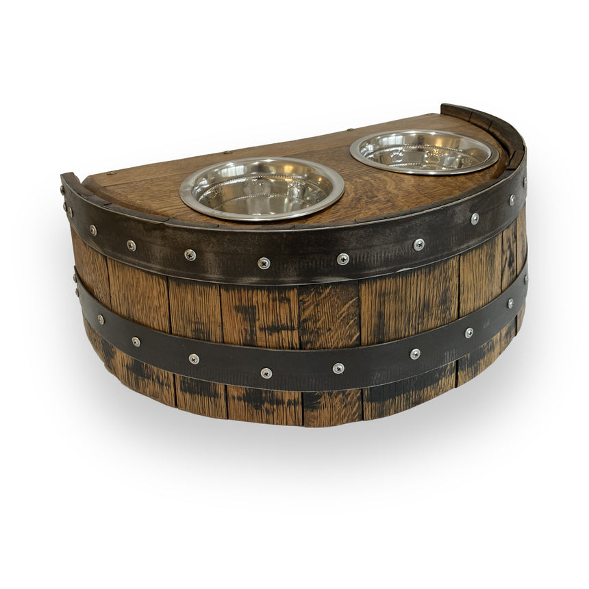 The Whiskey Barrel Pet Feeder is crafted from a half-barrel of wood and features two stainless steel bowls on top—a charming and stylish feeder for your beloved pets.
