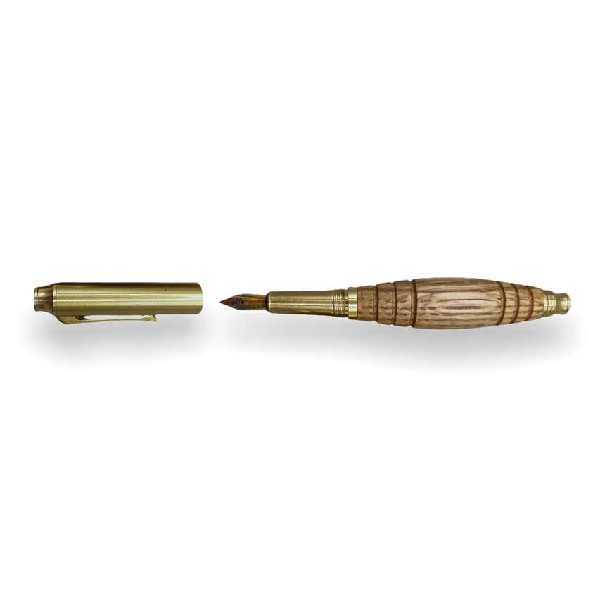 The Bourbon Barrel Fountain Pen, handcrafted from reclaimed Kentucky bourbon barrels with gold and wood accents, is shown uncapped beside its lid on a white background.