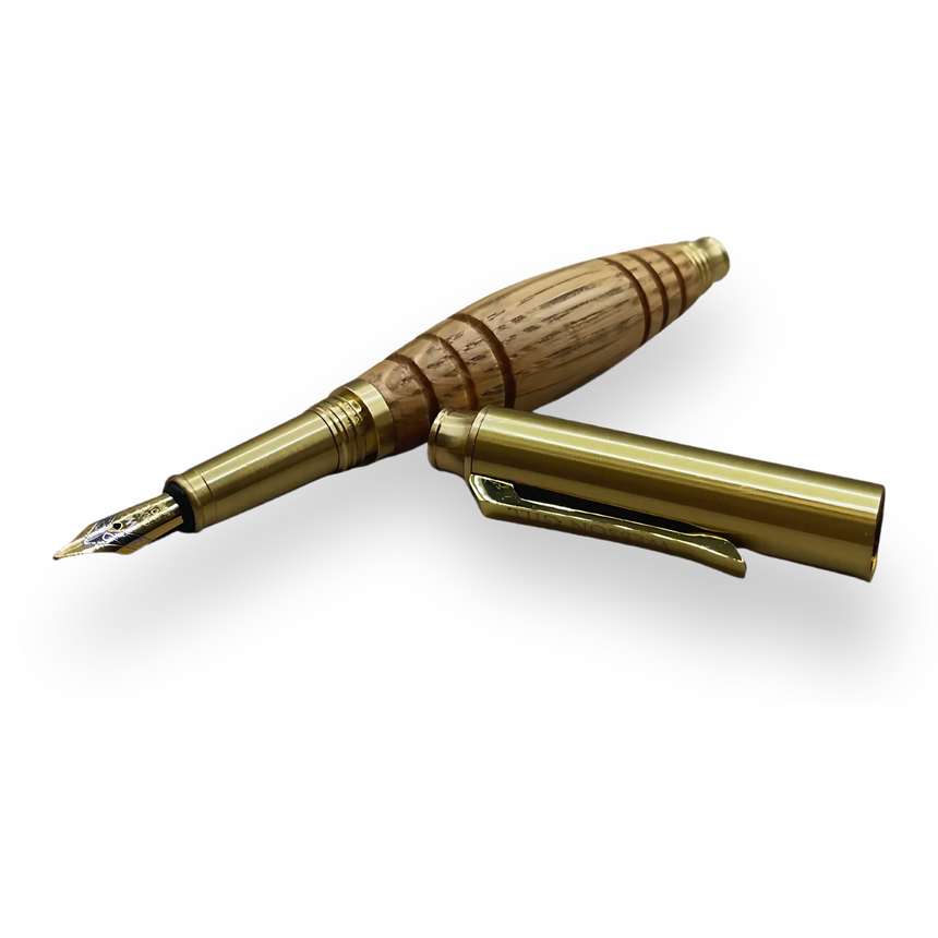 The Bourbon Barrel Fountain Pen, handcrafted from reclaimed Kentucky bourbon barrels with a gold nib and cap, is displayed on a black background.
