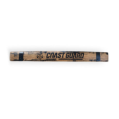A "Barrel Staves" wall sign, crafted from reclaimed oak with "COAST GUARD" and emblem printed on it, features black metal accents.