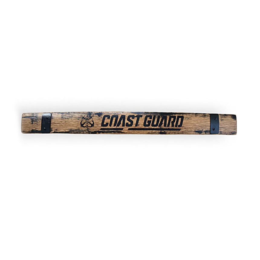 A "Barrel Staves" wall sign, crafted from reclaimed oak with "COAST GUARD" and emblem printed on it, features black metal accents.