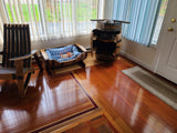 A cozy room with wooden chairs, a premium **Dog Bed - A005** priced at $225, a wine barrel cabinet, and sunlight streaming through vertical blinds.