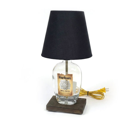 The Four Roses Lamp exudes rustic elegance, featuring a repurposed Four Roses bottle, black shade, yellow cord, and a wooden base.