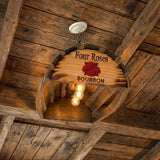 The Billiards Pool Table Overhead Light with 4 Bulbs, crafted from hand made solid wood barrel staves, hangs from a rustic wooden ceiling, making it perfect game room lighting for any billiards pool table.