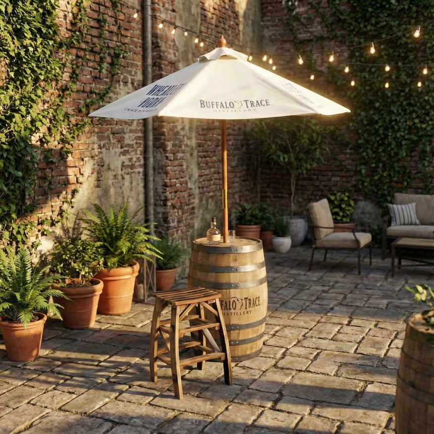 A patio with potted plants, a Patio Pub Table, a stool, and an umbrella set under string lights.
