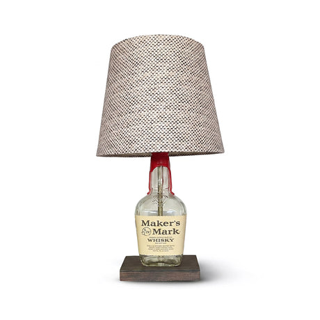 Brighten your space with the Maker's Mark Lamp, crafted from a bourbon bottle and topped with a patterned fabric shade—an ideal piece to add distinctive charm to your home decor.