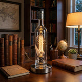 The Eagle Rare Lamp, featuring a vintage bourbon bottle design, sits on a desk with books, a globe, and a glowing light, creating a cozy study atmosphere.