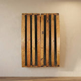 The hand made solid wood Barrel Stave Dart Board Cabinet fits a standard tournament dart board and is mounted on a light-colored textured wall above a wooden floor, adding unique style to any game room or DIY inspiration.