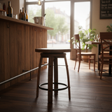 The Bar Stool Round Wooden Seat adds rustic charm to a cozy café, where sunlight streams through large windows and highlights the warm wooden floors.