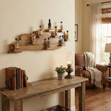 The Kentucky Wood Map Shelf holds liquor bottles on the wall above a rustic table with books, a lamp, plant, and a cozy armchair in the living room.