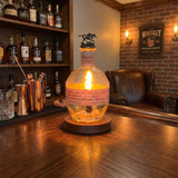 A Blanton’s Lamp adds elegant illumination to a cozy whiskey lounge, enhancing the atmosphere as it glows on the wood-paneled bar counter.