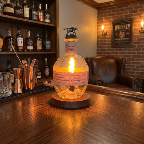 A Blanton’s Lamp adds elegant illumination to a cozy whiskey lounge, enhancing the atmosphere as it glows on the wood-paneled bar counter.