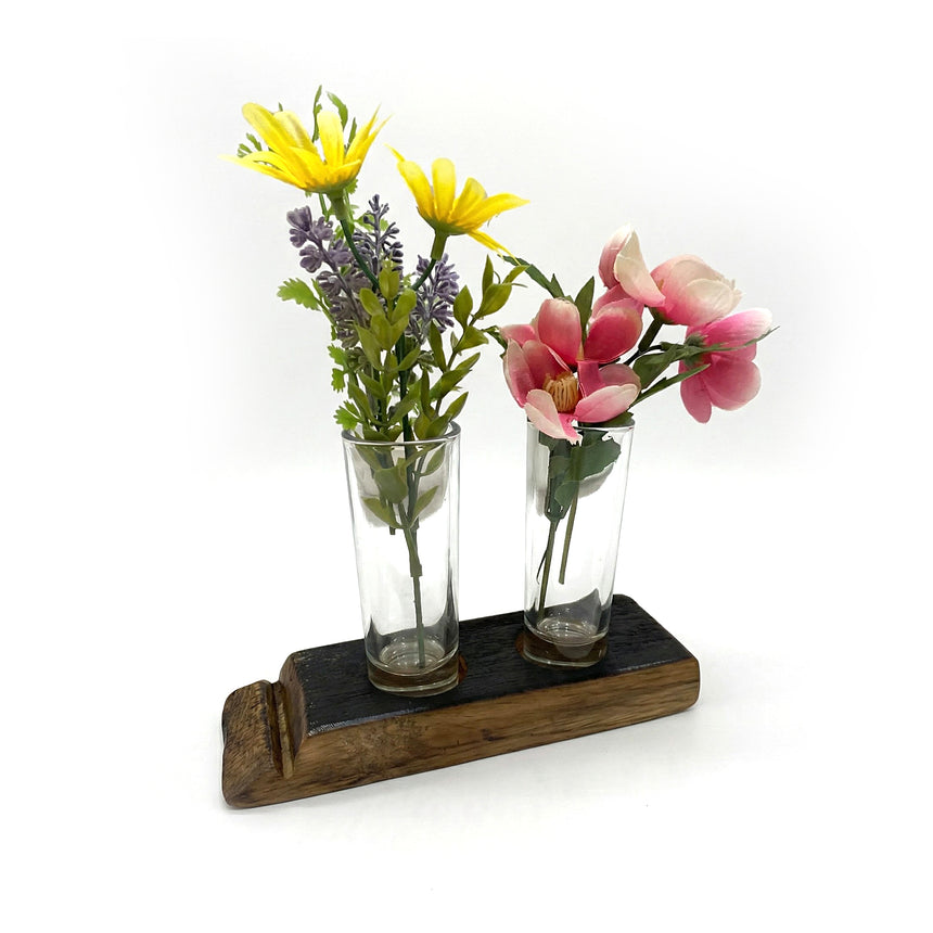 The Double Bud Vase Whiskey Staves display two glass vases with yellow and pink artificial flowers, creating charming rustic home decor against a white background.