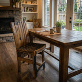 Handmade solid wood dining chair with barrel stave construction, set in a cozy sunlit room overlooking a green backyard for unique rustic character.