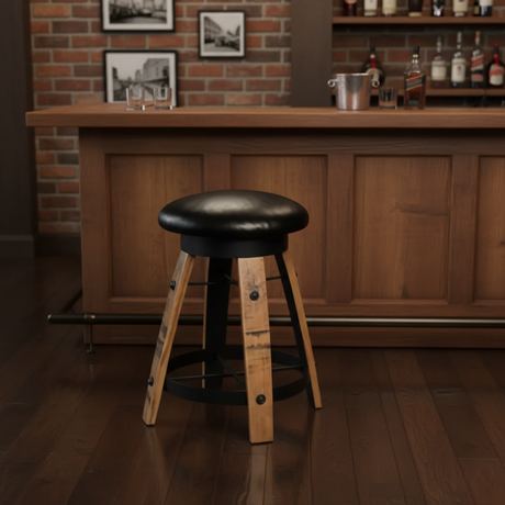 A Bar Stool Cushioned Seat Without Back with a black seat sits in front of a wooden bar counter, enhancing the cozy, rustic charm of the bar setting.