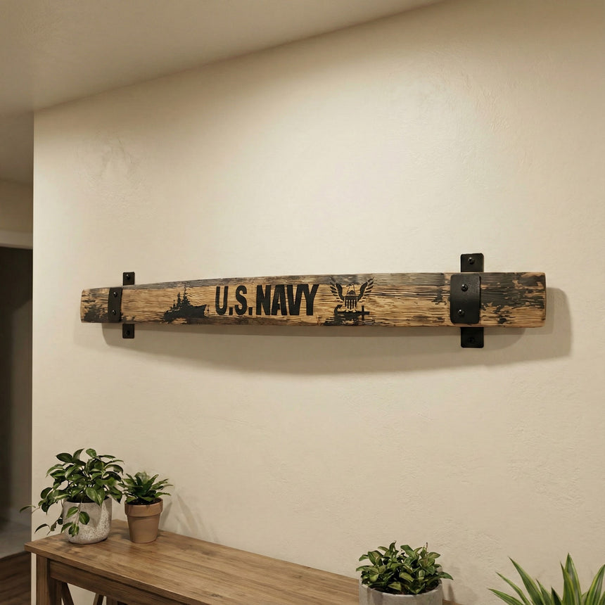 A rustic wall art piece made from Barrel Staves, featuring "U.S. NAVY" text and nautical symbols, is displayed above a table adorned with potted plants.