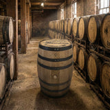 A Clean Full Barrel With Logo Head stands upright in a room lined with rows of aging barrels stacked on racks.