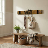 A bench with a plaid blanket, basket of dog toys, and a Leash Holder that organizes your leash, keys, and dog tote bag.