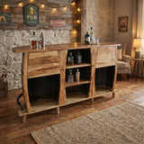 The 3 Barrels Bar Table adds rustic charm to any room with its wooden design, shelves for bottles, warm lighting, and vintage wall signs—ideal furniture for the perfect man cave.