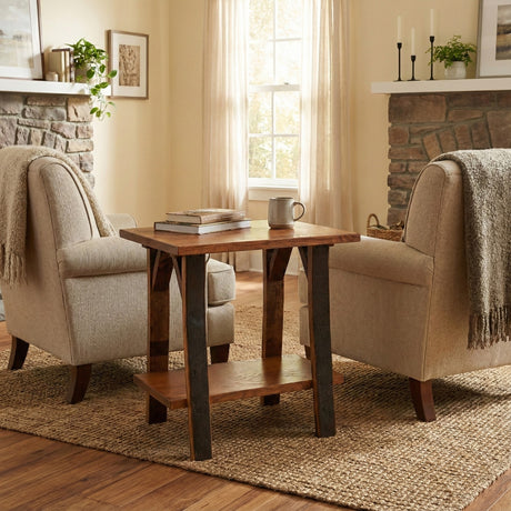 Two beige armchairs and a Barrel Side Table sit on a woven rug in a cozy, sunlit living room with stone fireplaces.